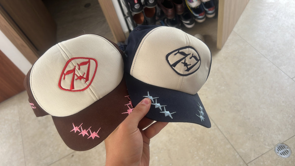 77 Emblem Cap in Mocha – Rose and Navy – Sky, held side by side